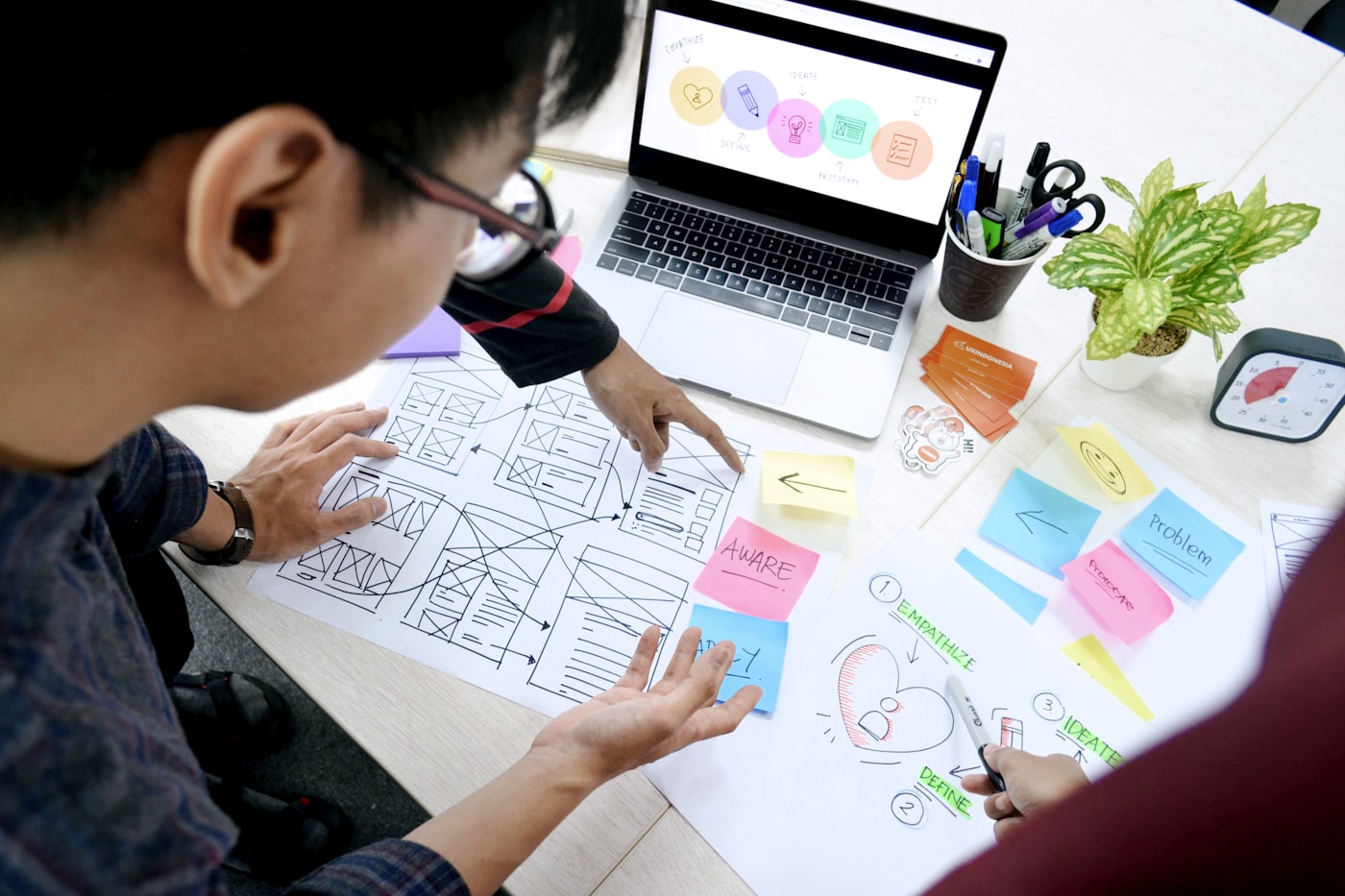 Web development agency UX researchers reviewing landing page wireframes