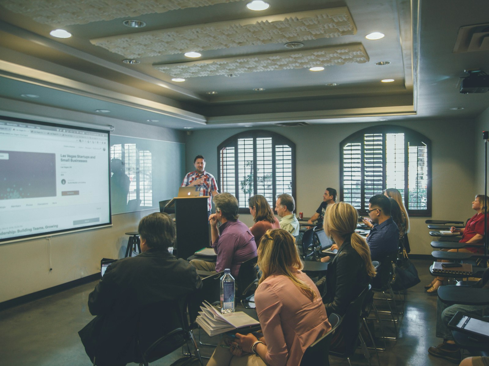 A coach presenting to an engaged membership community at a live mastermind session