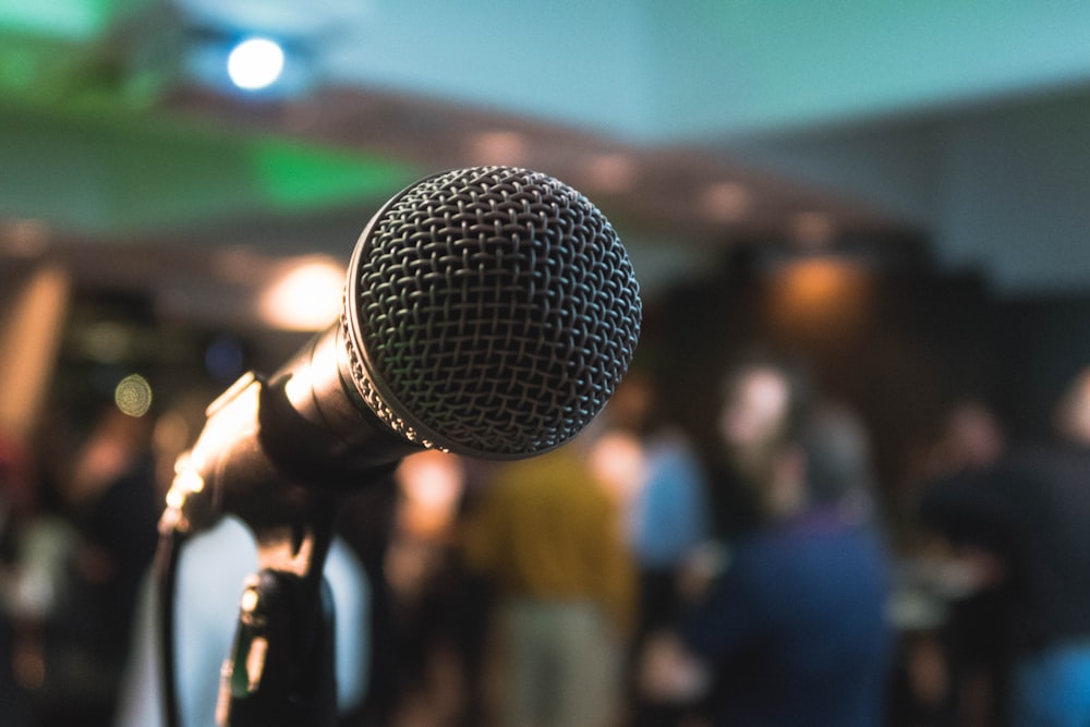 A microphone at the front of a room, ready for a speaker